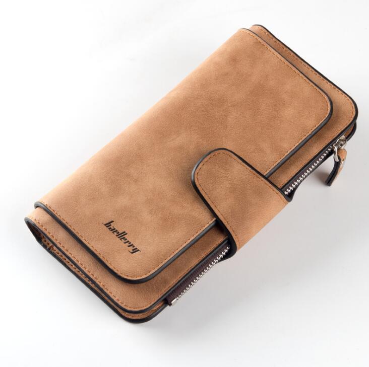Tan suede women's wallet with black trim, flap closure, zipper pocket, and embossed Baellerry logo.