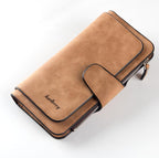 Tan suede women's wallet with black trim, flap closure, zipper pocket, and embossed Baellerry logo.