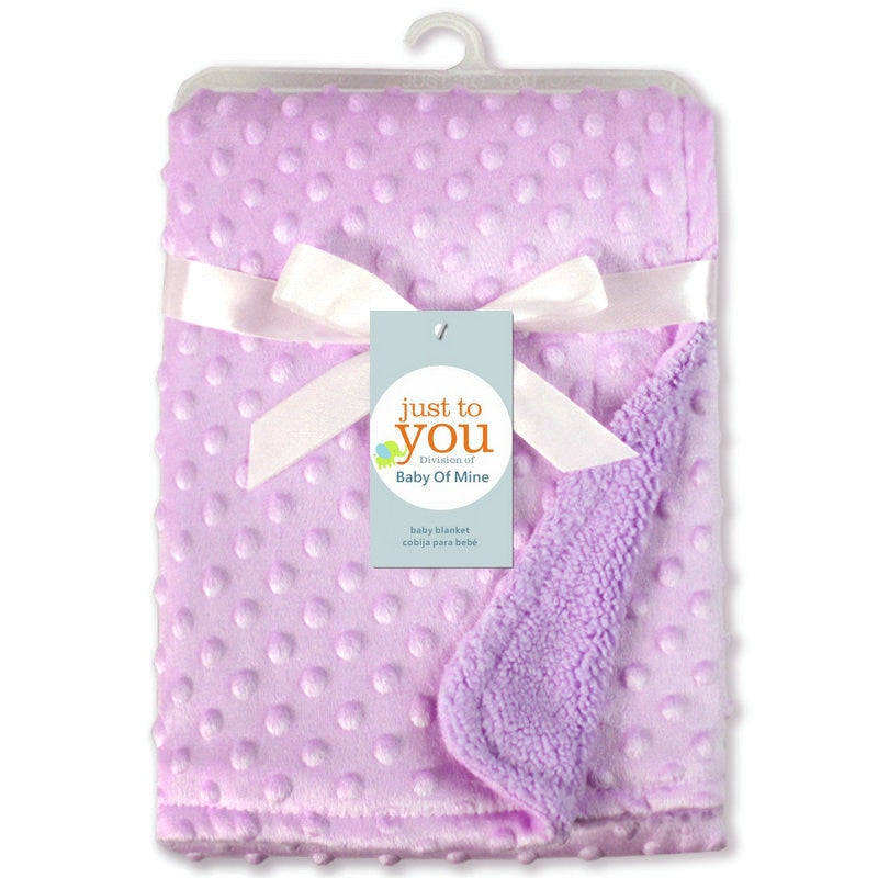 Soft lavender baby blanket with a textured dimpled polka dot pattern and satin ribbon bow, folded in packaging.