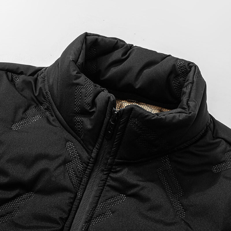Close-up of a black winter jacket with a textured, dotted graphene pattern, zip-up high collar, and gold inner lining.