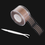 A roll of beige, adhesive double-eyelid stickers with a white applicator tool on a black background.