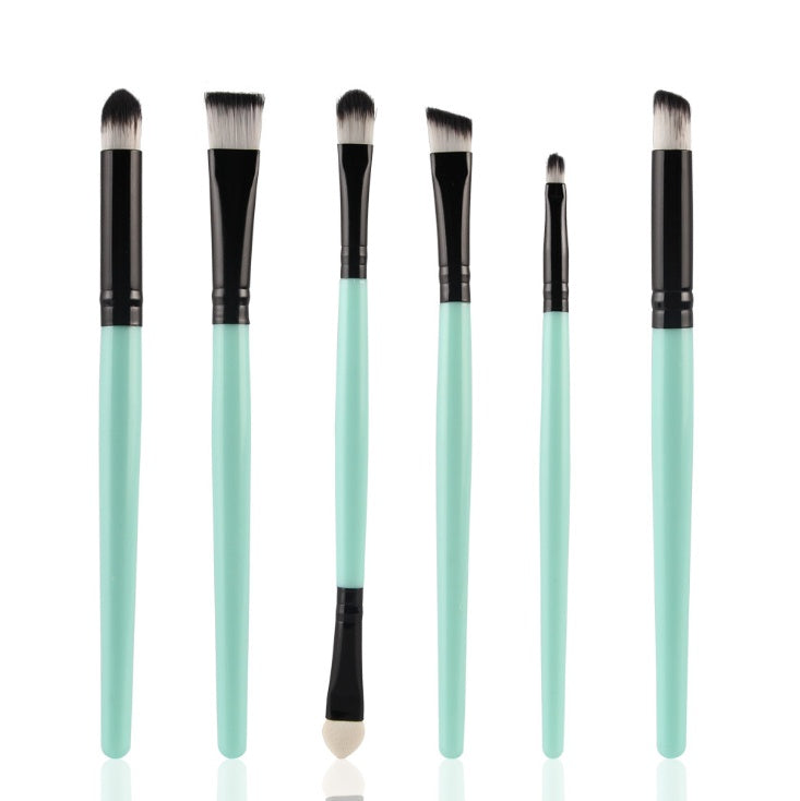 Six-piece makeup brush set with mint green handles, black ferrules, and soft white-tipped synthetic bristles.