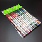 Twelve MKNK glitter eye and lip liner pencils in assorted colors, packaged in a clear plastic sleeve.