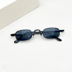 Black retro-style sunglasses with small, rectangular dark lenses and thin metal frames against a plain white background.