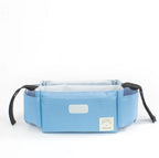 Light blue fabric stroller organizer with side cup pockets, white interior, and black adjustable velcro straps.