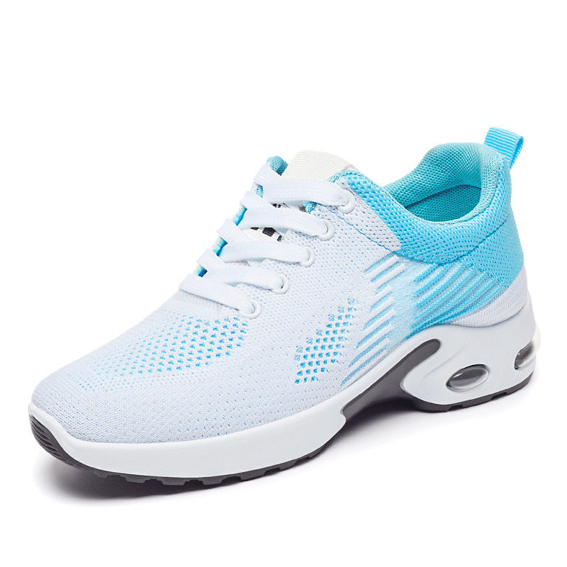 Women's white and blue knit running shoe with lace-up closure, breathable mesh, and cushioned air-sole heel.