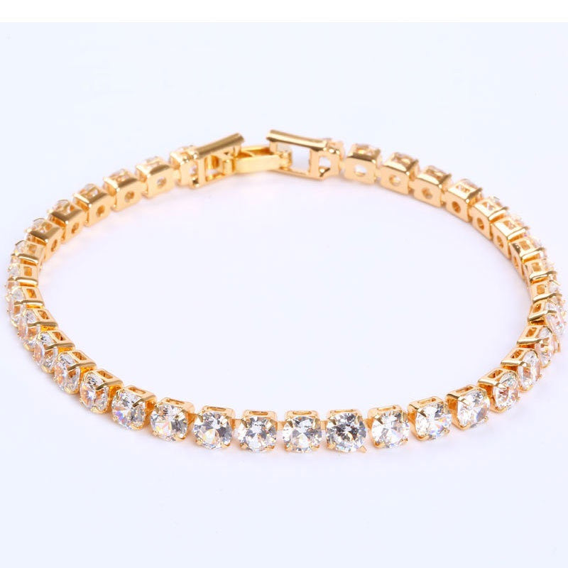 Gold-tone tennis bracelet featuring a row of sparkling micro-inlaid clear zircon stones and a secure clasp closure.