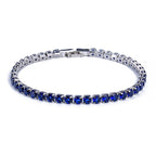 Silver-tone tennis bracelet featuring a row of micro-inlaid round blue zircon stones with a secure metal clasp.