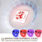 Four silicone LED face masks in blue, red, purple, and pink, featuring a honeycomb matrix design for light therapy.