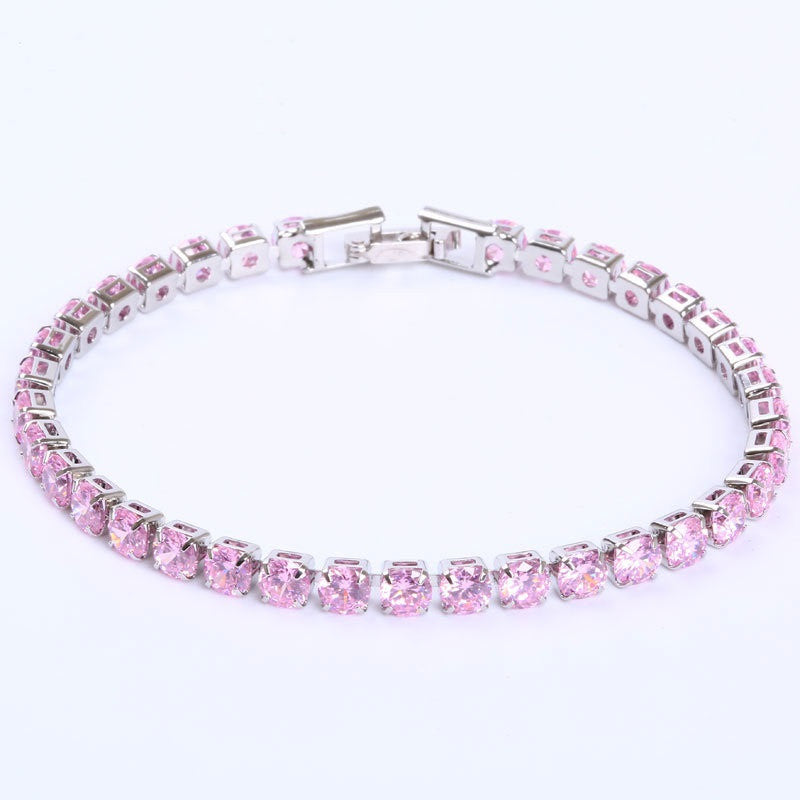 A silver-tone hip-hop tennis bracelet featuring a single row of round, sparkling pink zircon stones.