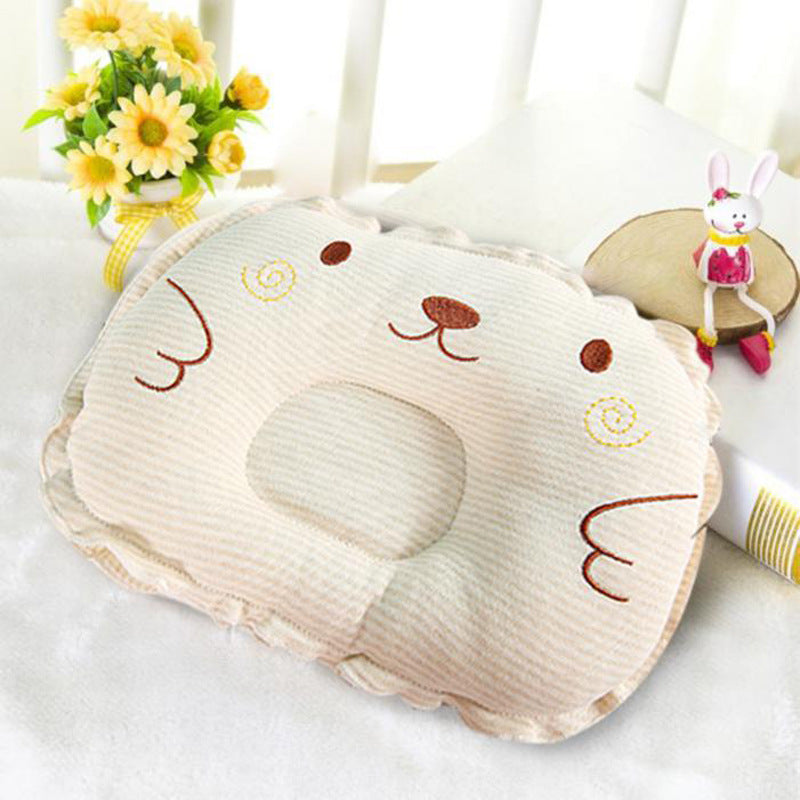 Beige corduroy baby pillow with embroidered animal face, central head indentation, and ruffled edge trim.