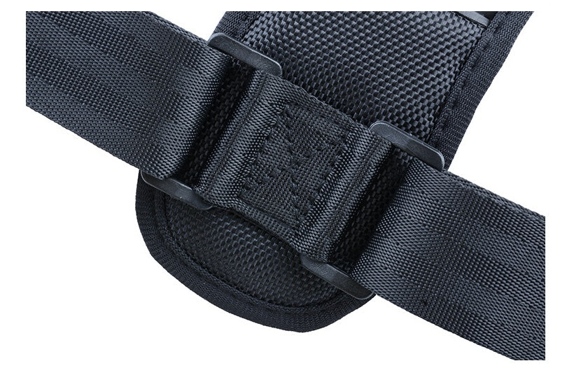 Black medical posture corrector strap featuring padded mesh fabric, adjustable nylon webbing, and plastic buckle hardware.