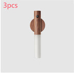 Magnetic wood LED motion-sensor light with white frosted shade, circular mounting base, and modern minimalist design.