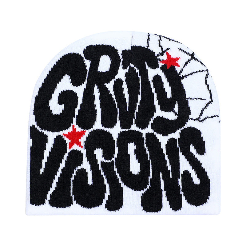 White knitted beanie with black "GRTY VISONS" graffiti text, red star accents, and spiderweb detailing on the side.