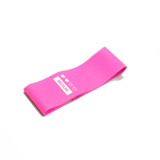 A bright pink, flat rubber resistance band labeled "MEDIUM" with three heart icons, isolated on a white background.