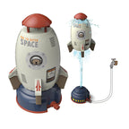 White and blue rocket sprinkler toy. It launches using hose water pressure to spray water for summer outdoor play.