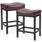 Two brown faux leather saddle bar stools with black steel frames and decorative brass nailhead trim.