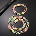 Gold-tone Cuban chain set with multicolored enamel accents and rhinestone pavé, featuring a box clasp closure.