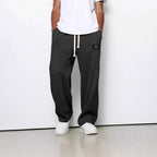 Charcoal grey waffle-knit straight pants featuring an elastic drawstring waist and small logo patch.