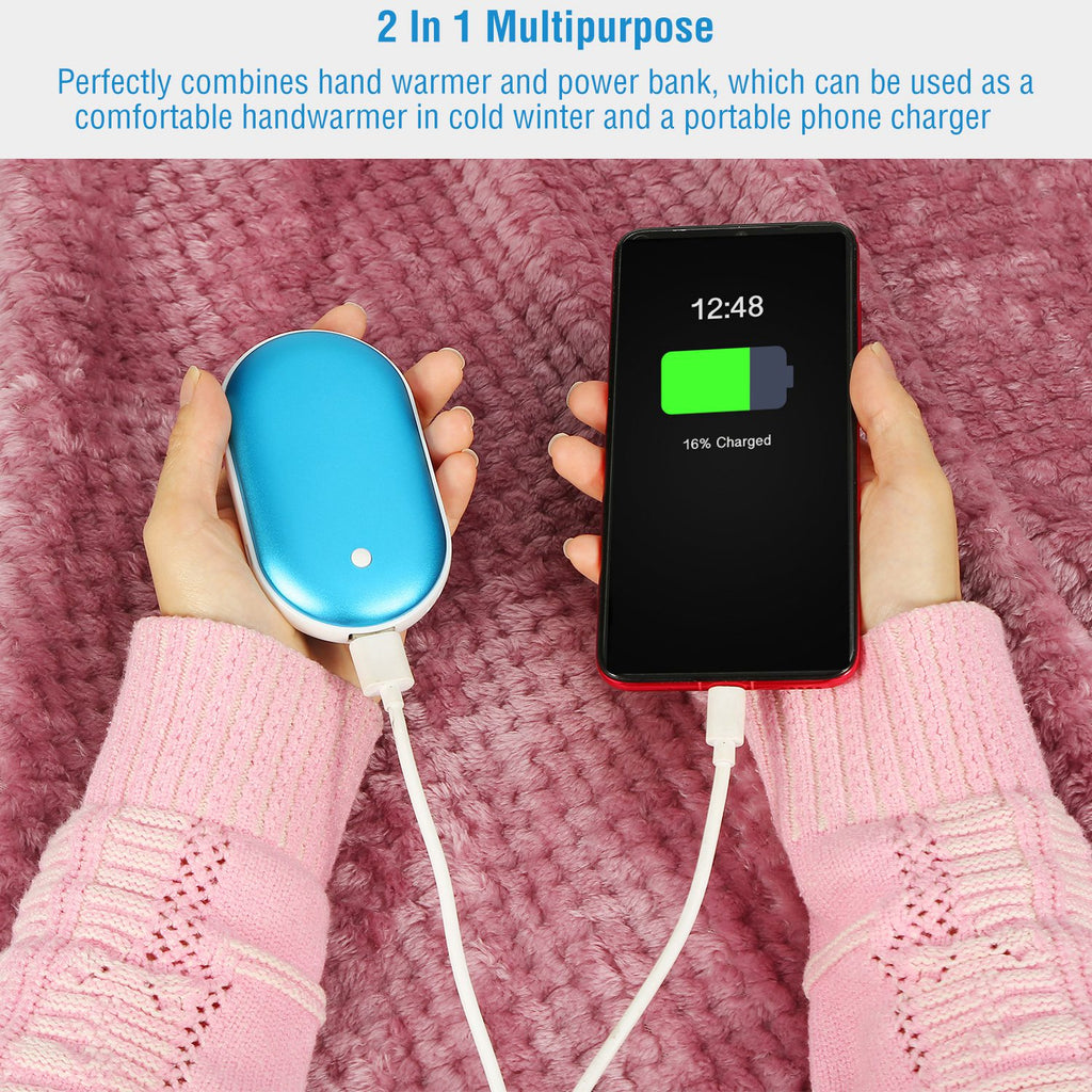 Blue portable hand warmer and power bank charging a smartphone, held against a fuzzy pink background.