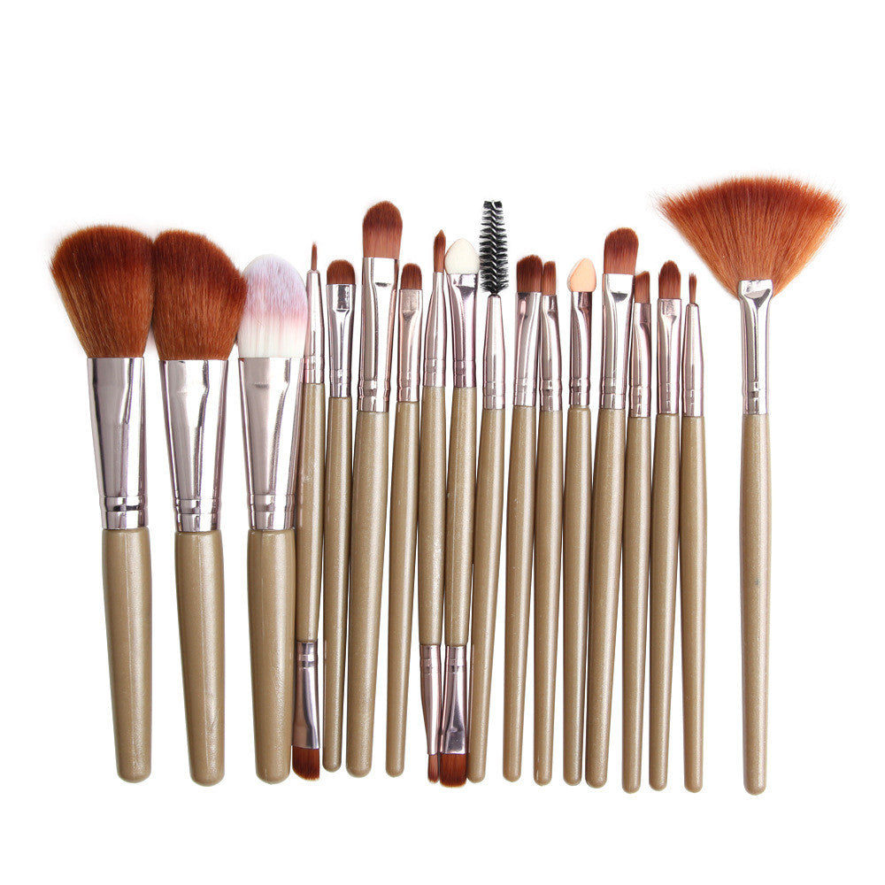 18-piece makeup brush set with brown bristles, silver ferrules, and metallic champagne handles on white background.