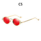 Steampunk sunglasses with vibrant red round lenses and ornate, etched gold-tone metal frames.