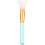 White silicone face mask brush with gold ferrule and light blue handle against a white background.