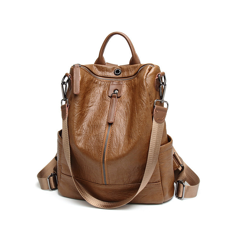 Brown soft leather multifunctional backpack with top handle, metal zippers, and adjustable webbing shoulder straps.
