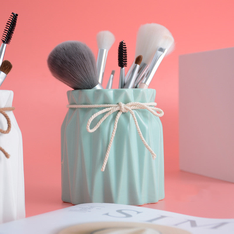Mint green faceted ceramic makeup brush barrel by Digitaldistribution375, tied with a decorative rustic twine bow.