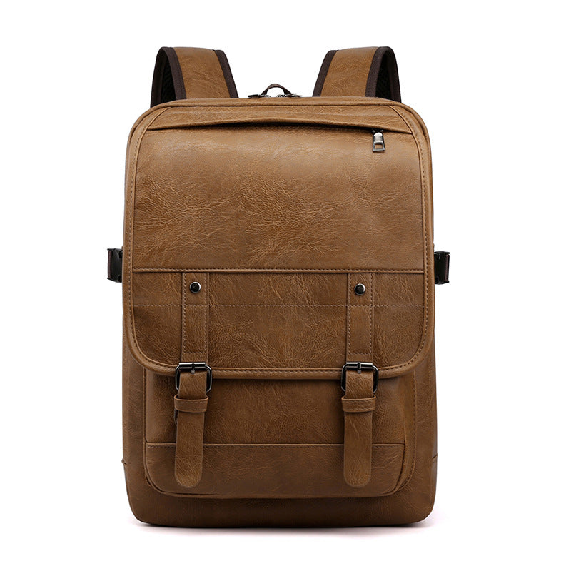 A retro-style brown leather backpack with two buckled straps, top zipper, and adjustable shoulder straps.