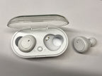 Digitaldistribution375 white wireless in-ear headphones with a charging case featuring a clear plastic flip-top lid.