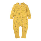 Yellow baby cotton sleeper with black star print, long sleeves, and an asymmetrical front zipper closure.