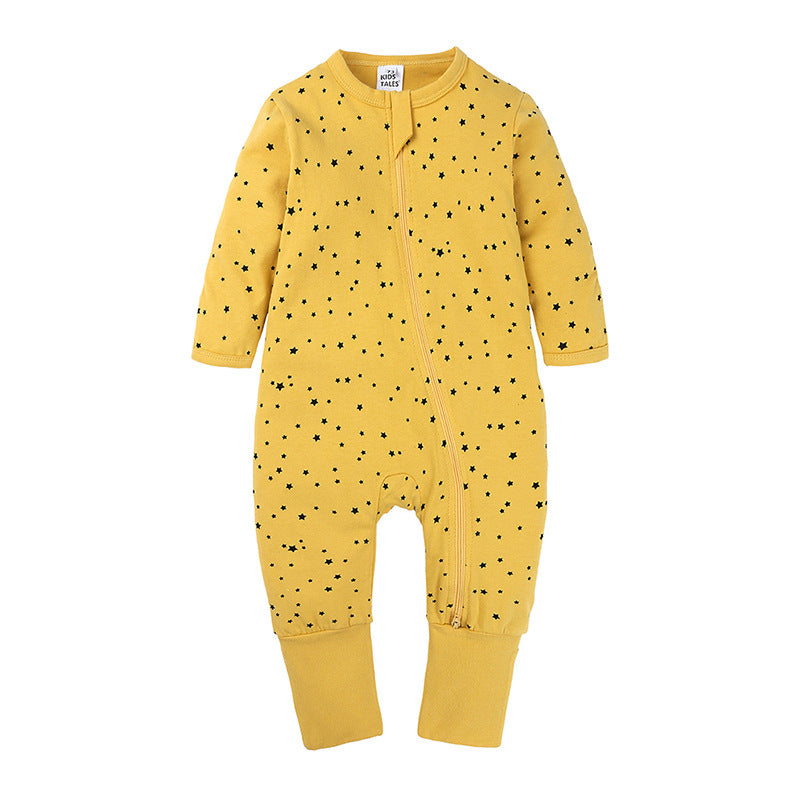 Yellow baby cotton sleeper with black star print, long sleeves, and an asymmetrical front zipper closure.