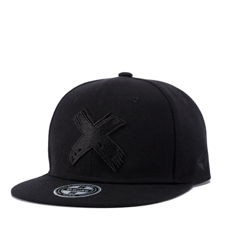 Black cotton hip-hop flat-brim cap featuring a textured embroidered X logo on the front and a round branded sticker.
