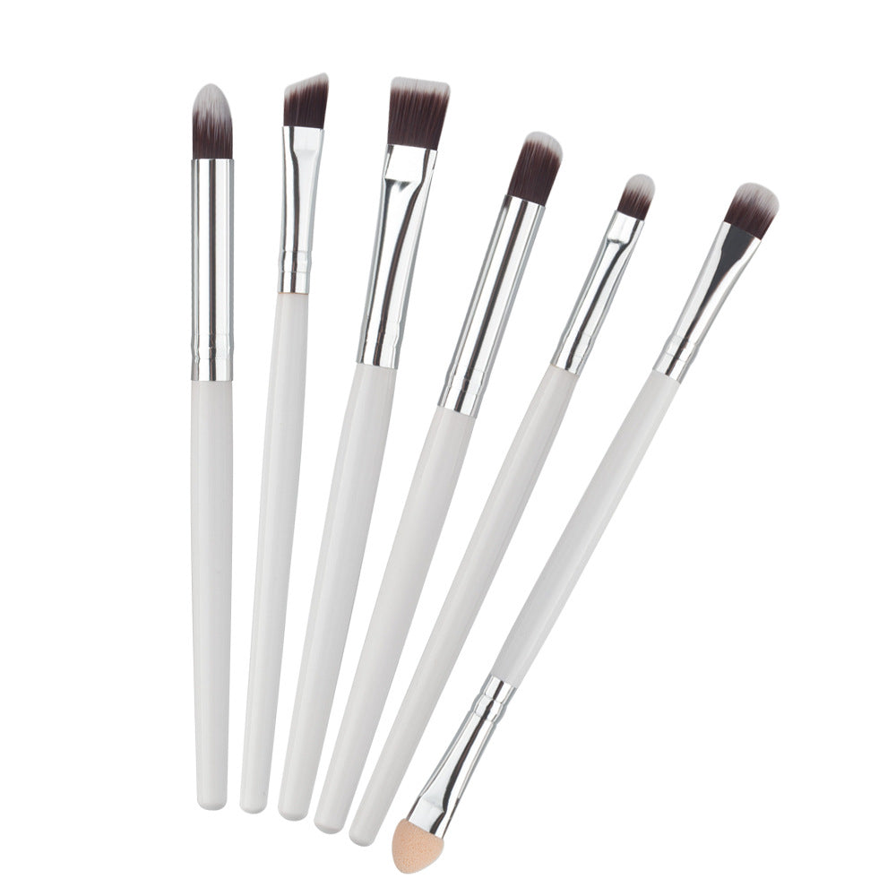 Six-piece eye makeup brush set with white handles, silver ferrules, and soft dark-tipped bristles.