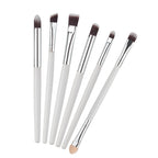 Six-piece eye makeup brush set with white handles, silver ferrules, and soft dark-tipped bristles.
