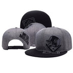 Grey and black Metal Mulisha snapback hats featuring skull-in-helmet embroidery and structured flat brims.