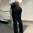 Black high-waisted cargo pants for women, featuring a fitted stretch design with multiple utility pockets.