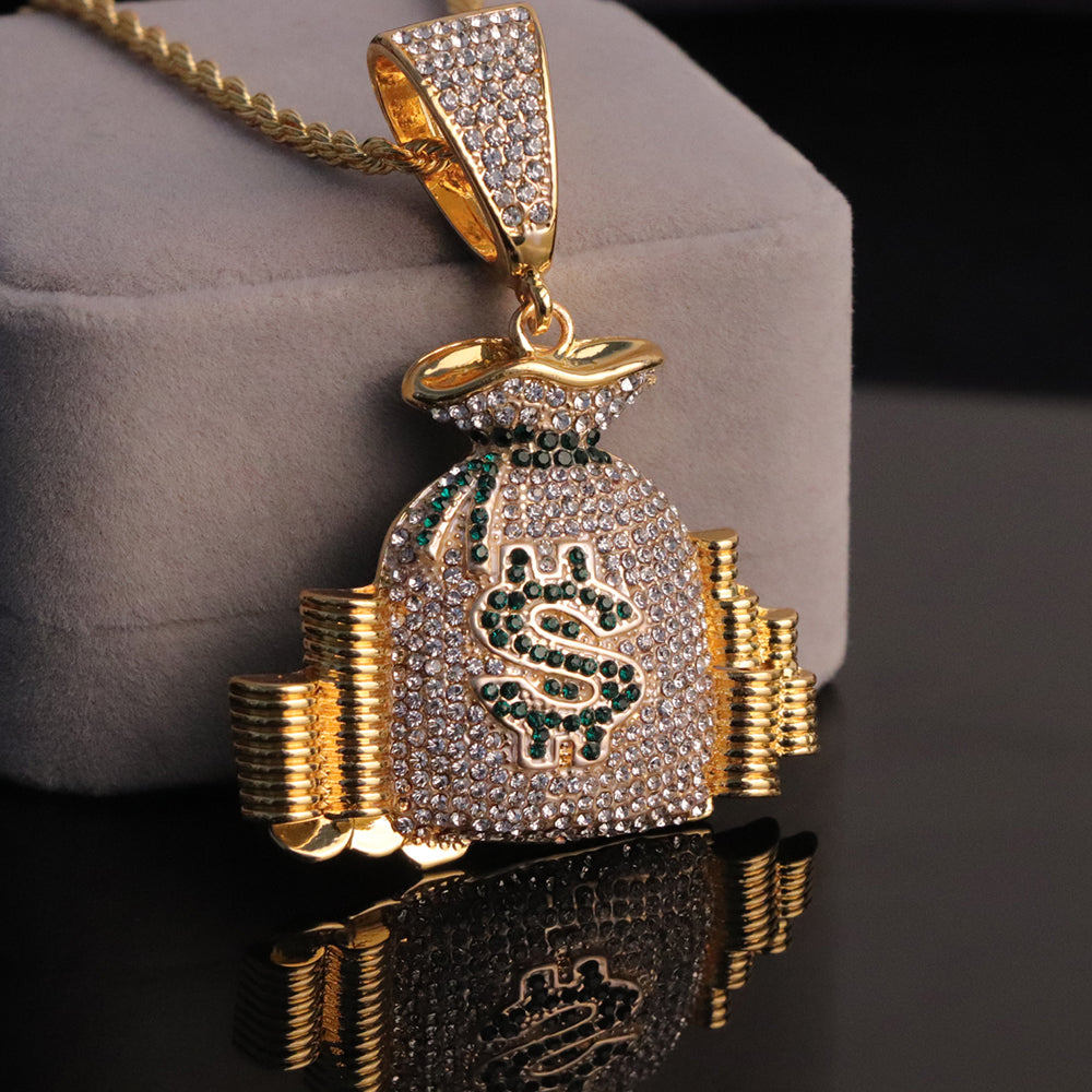 Gold-tone hip-hop money bag pendant necklace encrusted with white and green crystals on a rope chain.