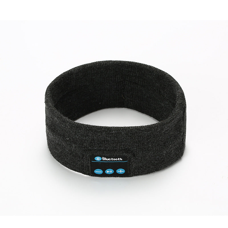 Dark gray fabric Bluetooth fitness headband with built-in control panel for audio, isolated on white background.