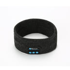 Dark gray fabric Bluetooth fitness headband with built-in control panel for audio, isolated on white background.