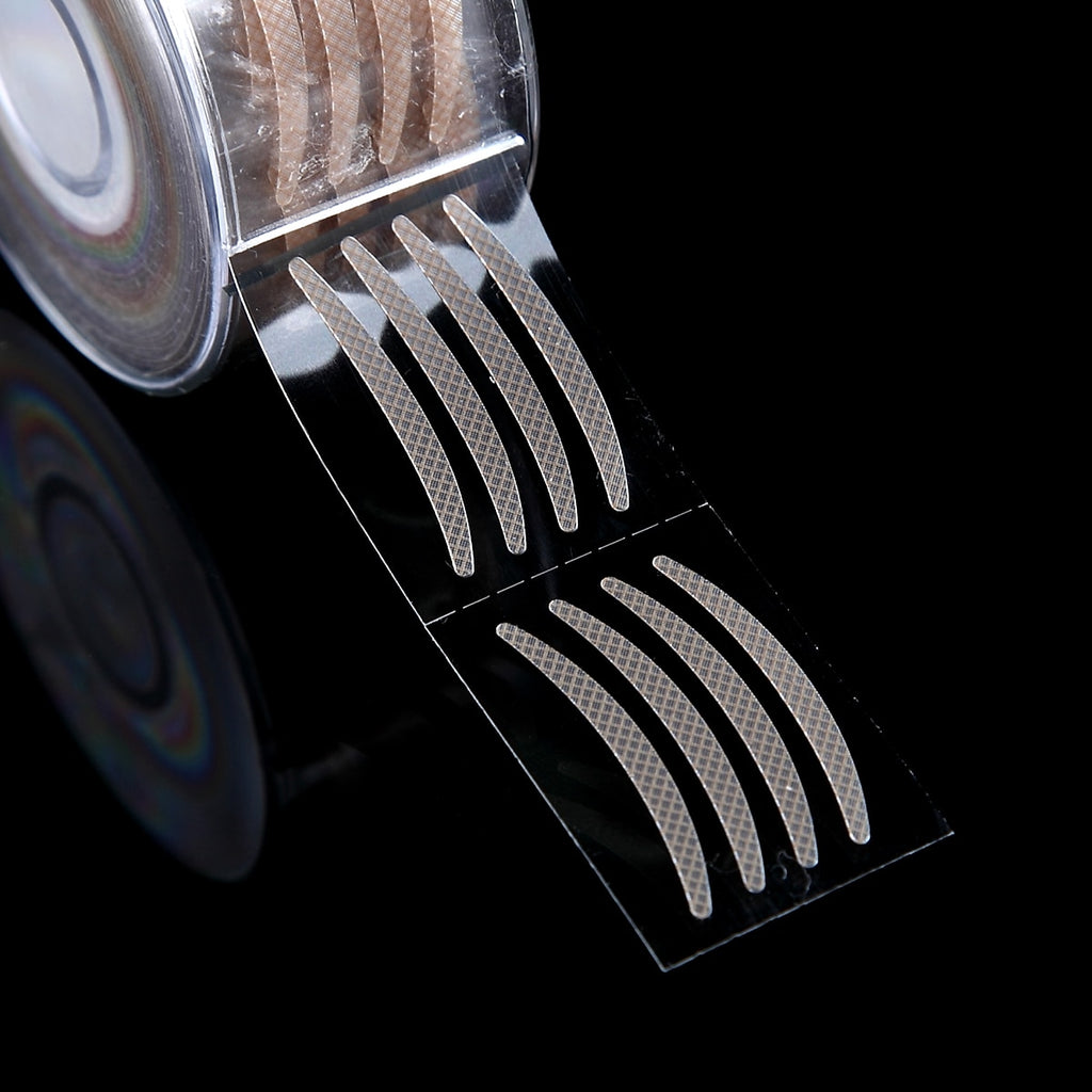Roll of 600 beige, mesh-textured, adhesive double eyelid strips on a clear plastic backing against a black background.