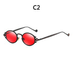 Steampunk sunglasses with round, vibrant red lenses and black engraved metal frames featuring intricate side details.
