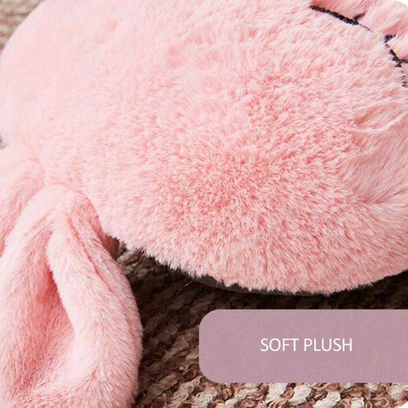Close-up of a pink, soft plush USB shoe warmer with a dark textured interior and a label reading "SOFT PLUSH."