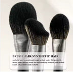 Three makeup brushes with black synthetic bristles and brushed silver ferrules against a light background.