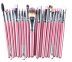 A set of makeup brushes featuring pink wooden handles, silver ferrules, and soft synthetic bristles.