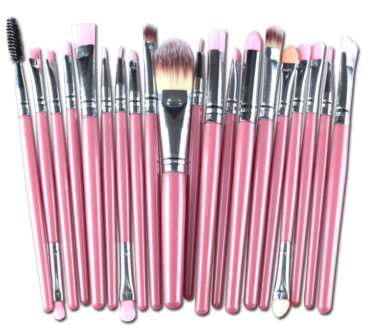 A set of makeup brushes featuring pink wooden handles, silver ferrules, and soft synthetic bristles.