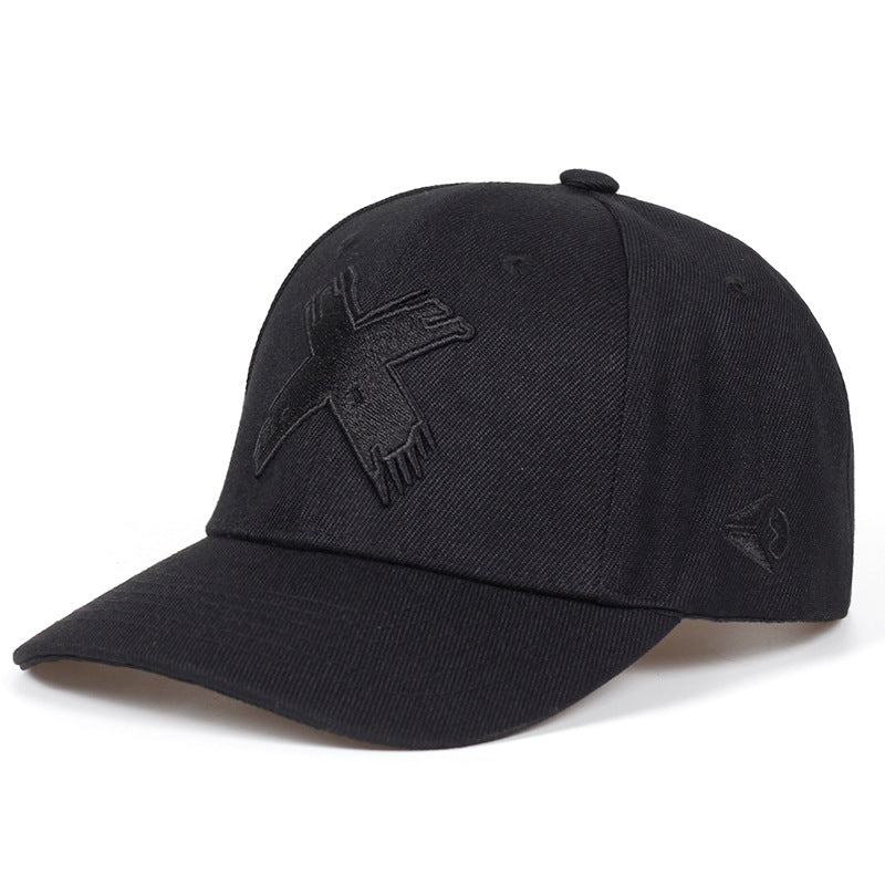 Black baseball cap with an embroidered "X" logo on the front and a small triangle symbol on the side.