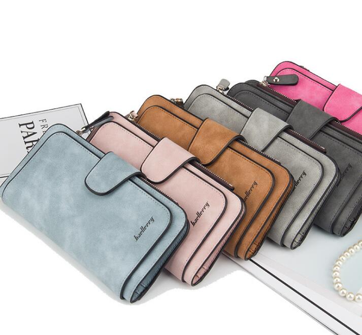 A row of suede-texture Baellerry wallets in blue, pink, tan, grey, and dark grey, featuring snap closures and zippers.