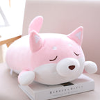 Cute pink and white Shiba Inu plush pillow with a soft, rounded body, closed eyes, and small, upright ears.